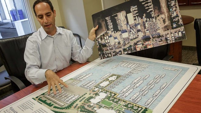 Rybovich vice president Carlos Vidueira shows past and current photos an drawings of the Rybovich property in West Palm Beach.