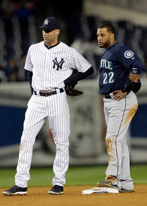 Derek Jeter, left, chats up his old teammate Robinson Cano on Tuesday night.