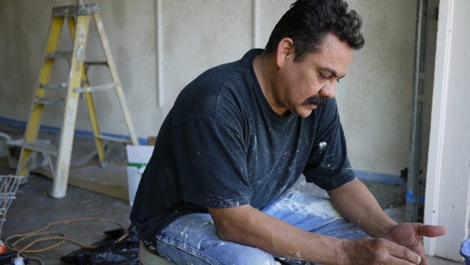 Abraham Perdomo, 48, takes a break from working on his house on Onion Creek Drive on Thursday April 24, 2014. Perdomo’s home was damaged in the Onion Creek flood on Halloween but is not eligible for a city buyout. Dave Harmon/American-Statesman