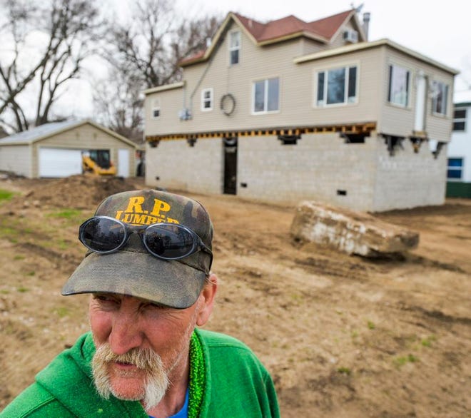 Contractor Dave Inman worked to elevate this home along North Front Street in Chillicothe for a couple who wished to keep their home along the Illinois River despite the destruction of last year's flood.