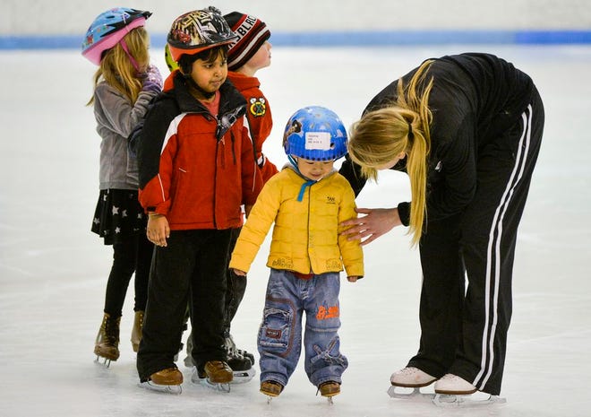 Children learn to skate with the help of instructors at Owens Center.