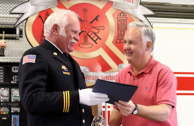 Rachel Rodemann • Times Record
Fort Smith City Administrator Ray Gosack presents a city proclamation to Fort Smith Fire Department Battalion Chief Larry Hall during Hall’s retirement ceremony Wednesday at the Fort Smith Fire Department. Hall worked at the Fire Department for 41 years.