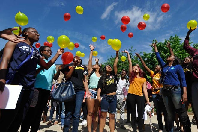 Students release balloons with their fears for the future written on them during a decision day ceremony at Clarke Central High School on Thursday, May 1, 2014, in Athens, Ga. During the ceremony, seniors announced their college choice to other students and members of the faculty. (AJ Reynolds/Staff, @ajreynoldsphoto)