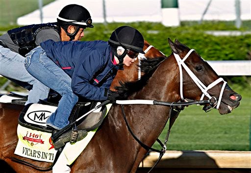 Jockey Rosie Napravnik, right, works Kentucky Derby hopeful Vicar's in Trouble with a stablemate at Churchill Downs in Louisville, Ky., Saturday, April 26, 2014.
