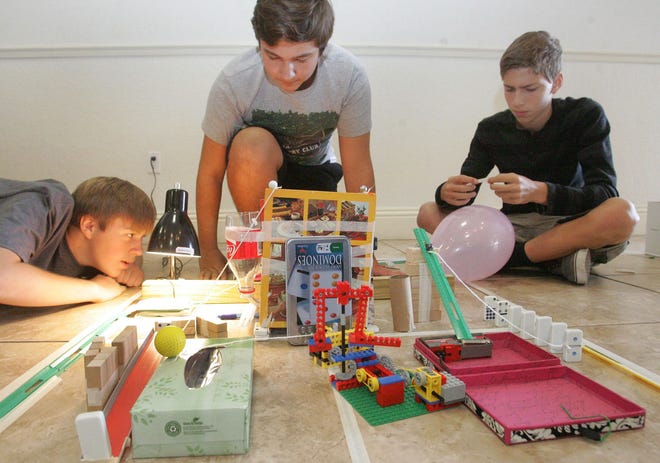 Thomas Verble, Ben Lewandowski and Stefan Moreno set up their machine Thursday as they join other teams from local middle schools at Bethune-Cookman University for the Rube Goldberg Machine Contest.