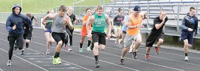 Fairless High School head track coach Ben Russell (second from right) leads his sprinters down the track during a Thursday practice session. The Falcons finished third overall during Saturday’s Stark County Championships.