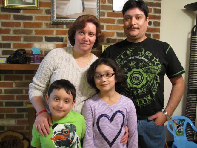 Cesar Andrade Vargas, right, standing with his wife Rosa along with their children in front Juan Roberto, left and Lupita Lizeth. Vargas will become an American citizen Friday after making Chestnut his home and learning English. Photo by Jean Ann Miller/The Courier.