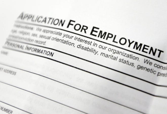 This April 22, 2014 photo shows an employment application form sits on a table during a job fair at Columbia-Greene Community College in Hudson, N.Y. The Labor Department releases employment data for April on Friday, May 2, 2014. (AP Photo/Mike Groll)