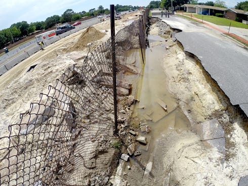 A portion of the boundary wall and Weaver Avenue on Hurlburt Field was damaged in this week's flooding.