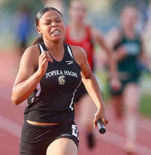Topeka High's Latiyera Yeargin strides to a first place finish in the girls 4x100 meter relay Friday night at the Seaman Relays.