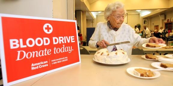 Frances Bryce, 92, cuts slices of her ‘Donor Cake’ at the blood drive at Shelby Presbyterian Church on April 22. Bryce has been volunteering for the American Red Cross since 1984.