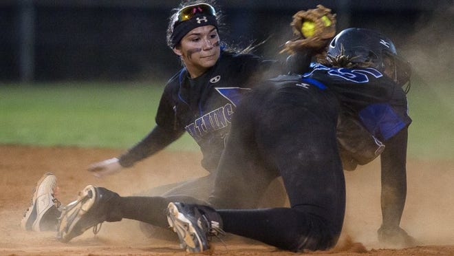 Park Vista’s Emily Lochten (right) slides safely into second base as Cypress Bay’s Lily Pruneda applies the tag too late in the regional final Friday in Boynton Beach. The Cobras rallied to force extra innings but fell 6-4 in 11 innings. (Madeline Gray / The Palm Beach Post)