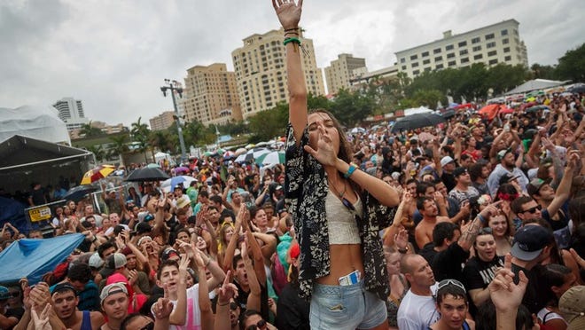 Jessica Hebler, Jupiter, dances in the rain with the crowd at the Dirty Heads performance on the Ford stage at SunFest 2014 in downtown West Palm Beach on Saturday, May 3, 2014. (Thomas Cordy / The Palm Beach Post)