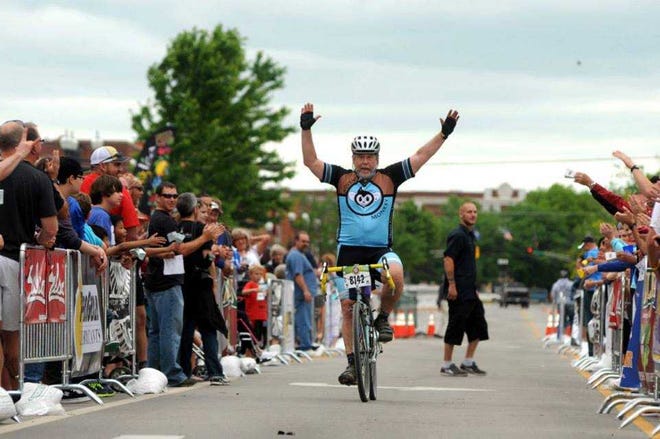 A rider and spectators celebrate as he crosses the finish line at last year's Dirty Kanza 200 in Emporia. The race draws from 3,000 to 6,000 people to the Lyon County town. This year the bicycle race will be May 31, and riders from 48 states and seven countries are expected to compete.