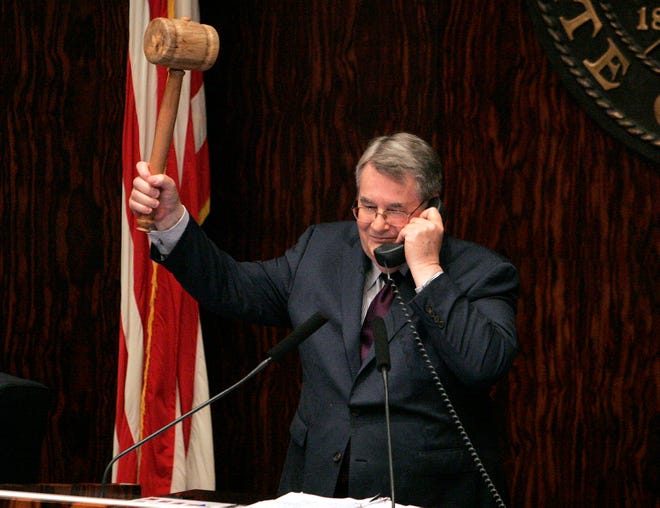 Senate president Don Gaetz, R-Niceville, talks with house speaker Will Weatherford on the phone as he prepares to bang the gavel to end the session on Friday night in Tallahassee. Florida legislators signed off on a record $77 billion budget.