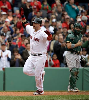 Red Sox catcher A.J. Pierzynski celebrates after hitting his first career home run at Fenway Park, a span of 168 at-bats in both the postseason and regular season. Pierzynski's seventh-inning home run tied the score at 2-2, but the Red Sox lost 3-2 in 10 innings.