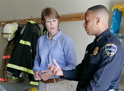 AP Photo/Steve Cannon
U.S. House candidate Gwen Graham listens to Police Chief and public safety director Carlos De La Cruz as he explains the workings of his department on Thursday, April 10, 2014, in Gretna, Fla. On campaign stops Graham had something going for her: her last name. Voter after voter recounted fond memories of her father, Bob, who towered over Florida politics for more than a quarter-century as governor and U.S. senator.