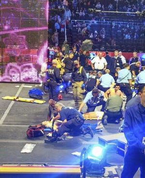 In this photo provided by Rose Viveiros, first responders work at the center ring after a platform collapsed during an aerial hair-hanging stunt at the Ringling Brothers and Barnum and Bailey Circus, Sunday, May 4, 2014, in Providence, R.I. At least nine performers were seriously injured in the fall, including a dancer below, while an unknown number of others suffered minor injuries.