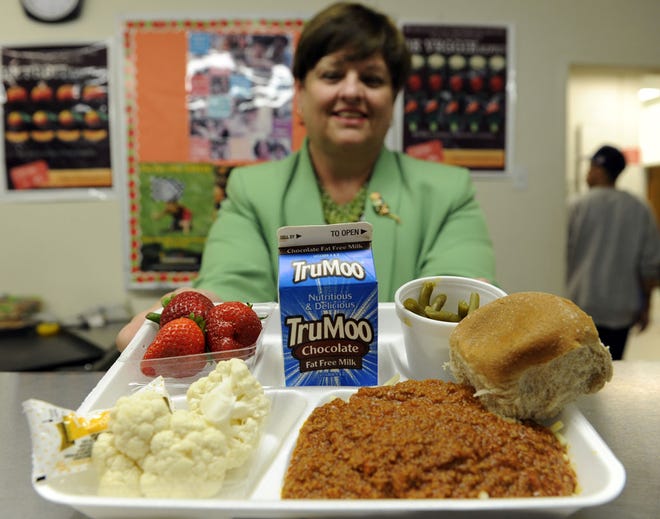 Becky Domokos-Bays, the Director of Food and Nutrition Services at Alexandria City Public Schools, holds up a tray of food during lunch service at the Patrick Henry Elementary School in Alexandria, Va., Tuesday, April 29, 2014.