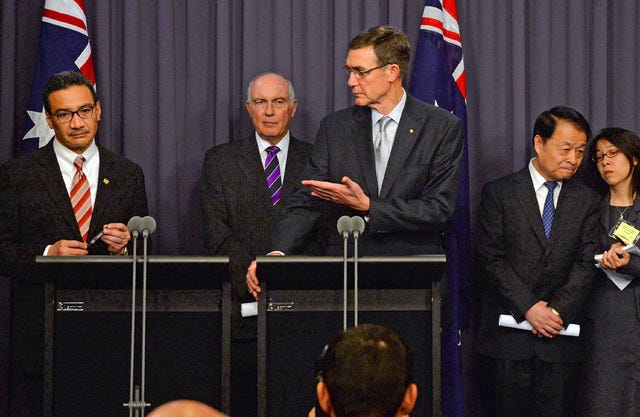 Australia's Transport Minister Warren Truss, second from left, Malaysia's acting Transport Minister Hishammuddin Hussein, left, and China's Transport Minister Yang Chuantang, second from right, attend a press conference for the nearly two-month-old hunt for the missing Malaysian jet with search coordinator Angus Houston, center, in Canberra, Australia, Monday, May 5, 2014. Senior officials from Malaysia, Australia and China are meeting in the Australian capital to hash out the details of the next steps in the search for Malaysia Airlines Flight 370, which will center around an expanded patch of seafloor in a remote area of the Indian Ocean off Western Australia. (AP Photo/AAP Image, Alan Porritt) NO ARCHIVING, NO SALES, AUSTRALIA OUT, NEW ZEALAND OUT, PAPUA NEW GUINEA OUT, SOUTH PACIFIC OUT 
 File-This April 7, 2014, file photo shows the chief coordinator of the Joint Agency Coordination Center retired Chief Air Marshall Angus Houston gesturing as he speaks to during a press conference in Perth, Australia. An international panel of experts will re-examine all data gathered in the nearly two-month hunt for the missing Malaysia jet to ensure search crews who have been scouring a desolate patch of ocean for the plane have been looking in the right place, officials said Monday, May 5, 2014. (AP Photo/Rob Griffith, File)