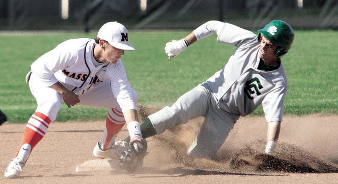 Massillon’s Matthew Machamer is tagged out by Central Catholic's Shawn Jones as he slides into third base during a game Tuesday.