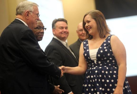 Jessica Rose Barker of Crest High School shakes hands with Cleveland County Board of Education member Jerry Hoyle at the Senior Scholars Banquet on Thursday.
