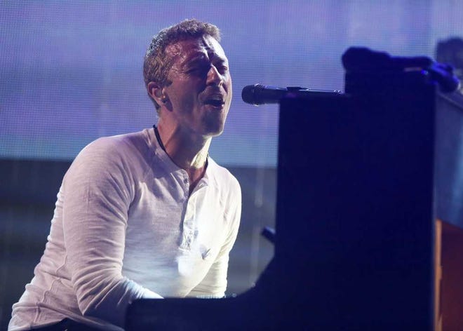 FILE - This March 11, 2014 file photo shows Coldplay's Chris Martin performing at the iTunes Festival during the SXSW Music Festival in Austin, Texas. Martin is bringing his expertise to NBC's music competition show "The Voice." The network said Martin will participate in the "battles" round that begins on March 31, advising singers on vocal technique and stage presence. (Photo by Jack Plunkett/Invision/AP, File)