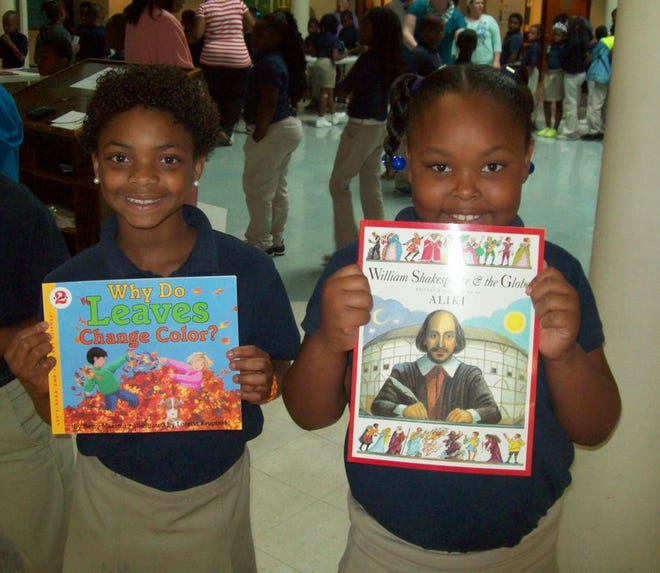 : From left, second graders Talaja Stevenson and Niannah Link proudly display their books received from the Ascension Parish Retired Educators at Donaldsonville Primary School.
