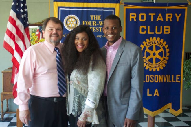 Rotarian Chuck Long stands with LaTangela Sherman of Cumulus Media, and Rotarian DeRon Talley after Sherman spoke to the club last week.