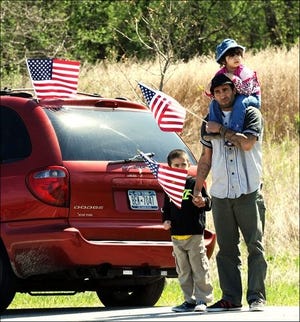 People line the road for the funeral procession of Sgt. Shawn Farrell, of Accord, N.Y.along Route 747 outside Stewart Airport on Wednesday, May 7, 2014.