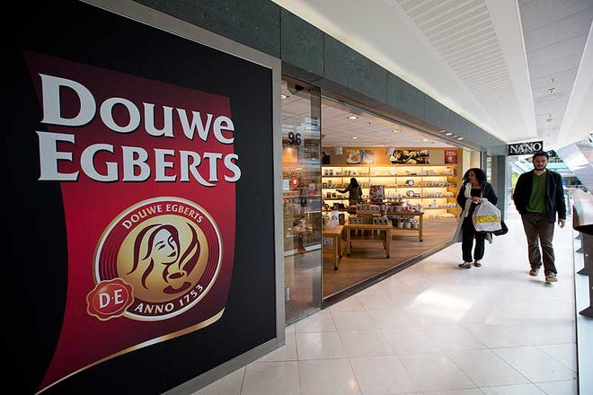 Shoppers pass by a Douwe Egberts cafe in a shopping mall in Amsterdam.