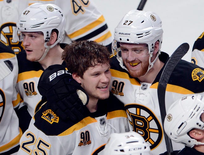 Rookie Bruins forward Matt Fraser (25) celebrates with Dougie Hamilton after scoring in overtime to give Boston a 1-0 win over the Canadiens in Game 4 of the Eastern Conference semifinals on Thursday night.