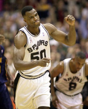 NBA BASKETBALL: ** FILE ** San Antonio Spurs center David Robinson (50) reacts after scoring against the Golden State Warriors in San Antonio, Tuesday, March 5, 2002, putting him over the 20,000 point mark for his career. Robinson, who was slowed by lower back injury this season, has scheduled a news conference for Friday afternoon. Robinson is expected to announce that he will retire after next season, according to a team source. (AP Photo/Eric Gay)