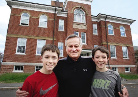 York Middle School eighth-graders Garrett and Brian Cronin pose with their grandfather, Fred LaBonte, in front of the school. At the end of May, 135 eighth-graders will travel to Washington, D.C., much as LaBonte's senior class did in 1958.