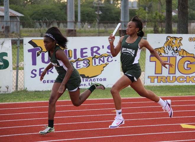 Plaquemine's Taejah Watkins takes the baton from Marlaisha Harris in the 4x100 meter relay earlier in the season. The Lady Green Devils won the Region II-4A track and field meet on Thursday.
POST SOUTH PHOTO/Peter Silas Pasqua