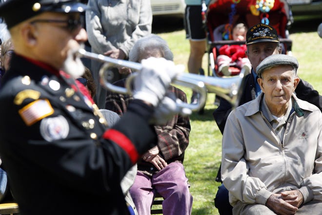 George Costa, right, looks on as Auston O’Neill plays Taps in his honor Wednesday at the Westport Camping Grounds.