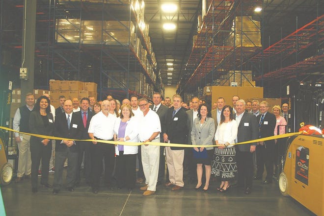 An open house for the Greencastle Armada Supply Chain Hub Center May 7 brought together the behind-the-scenes people involved in making the distribution center a reality in Antrim Township. Pictured in the center, from left: Ed Schreiber, operations project manager; Nancy Postrech, corporate service development; and Leo Kluczkowski, warehouse manager; who had the ribbon cutting honors before the group broke for speeches, a tour and lunch.