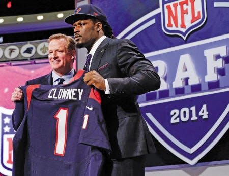 South Carolina defensive end Jadeveon Clowney (right) holds up a Houston Texans jersey with NFL commissioner Roger Goodell after being taken by Houston with the first pick in Thursday night’s NFL draft in New York.