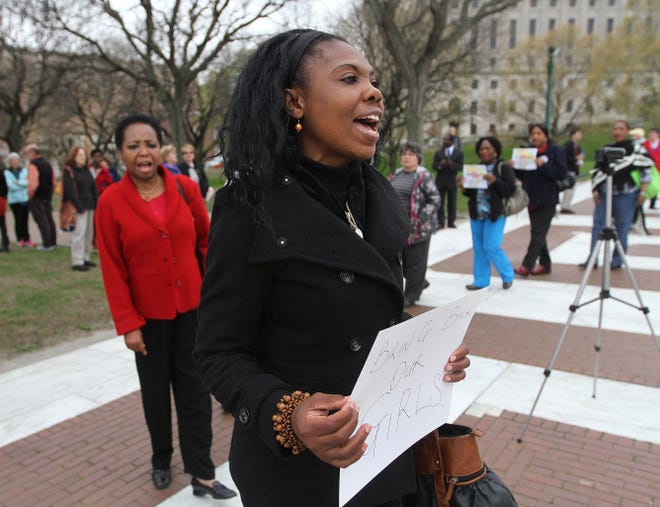 Francesca Agwunobi, of Smithfield, participates in a rally at the State House on Friday to support efforts to "Bring Back Our Girls," and get assistance for female students kidnapped by Boko Haram in northeast Nigeria.