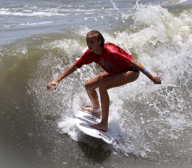 Jillian Bontempo rides a wall during the women’s final at the MayDay Memorial Surf Classic on the south side of the Flagler Beach Pier Saturday, May 10, 2014.