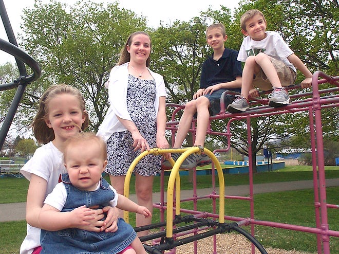 The Wheatons (from left) Alexis, age 8, Meghan, age 15 months, mom Michelle, Cody, age 10 and Scott, age 6, play on the train at the Thorne Street Park in Horseheads.