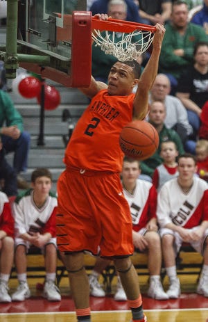 Lanphier’s Larry Austin Jr. leaps for a dunk against Lincoln in the first half at Roy S. Anderson Gymnasium, Friday, Feb. 28, 2014, in Lincoln, Ill. Justin L. Fowler/The State Journal-Register
