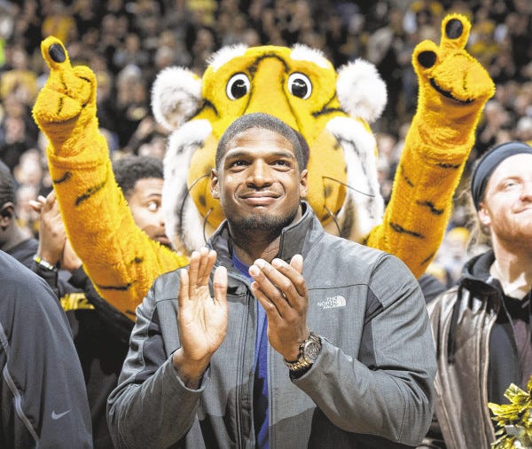 FILE - In this Feb. 15, 2014, file photo, Missouri's All-American defensive end Michael Sam claps during the Cotton Bowl trophy presentation at halftime of an NCAA college basketball game between Missouri and Tennessee in Columbia, Mo. Sam was selected in the seventh round, 249th overall, by the St. Louis Rams in the NFL draft Saturday, May 10, 2014. The Southeastern Conference defensive player of the year last season for Missouri came out as gay in media interviews this year. (AP Photo/L.G. Patterson, File) ORG XMIT: NY160