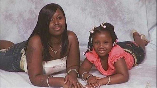 Kejuan Hall poses in this photo with daughter Takayia, who was 8 when Hall was brutally murdered in December 2010