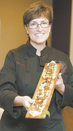 Sherry Schie shows off a dish at her restaurant Shy Cellars. Schie appeared on "Guy's Grocery Games" on Food Network.