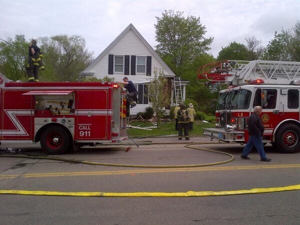 Firefighters knock down a house fire at 475 Union St. in Rockland on Tuesday, May 13, 2014.