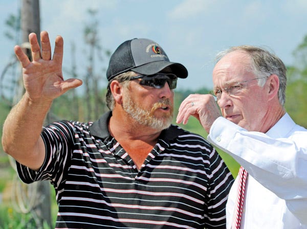 Jeffery Smith, who lost his chicken houses and suffered major damage to his home in the April 29 tornado, speaks Tuesday with Alabama Gov. Robert Bentley during a visit to see the tornado damage in the Smith Institute community of Etowah County.
