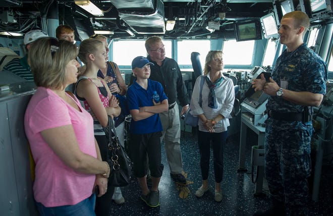Lt.j.g. Dustin Ellis explains navigation procedures to H. Delano Roosevelt and family during a ship tour aboard the Arleigh Burke-class guided-missile destroyer USS Roosevelt (DDG 80). Roosevelt is deployed as a part of the George H.W. Bush Carrier Strike Group supporting maritime security operations and theatre security efforts in the U.S. 5th fleet area of responsibility.