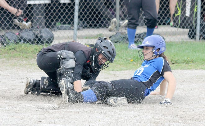 Waldron catcher Lindsey Lockwood tags out Pittsford's Mariah Natzke at home as she attempted to score on a pass ball at third base during Tuesday night's game. ANDY BARRAND PHOTO