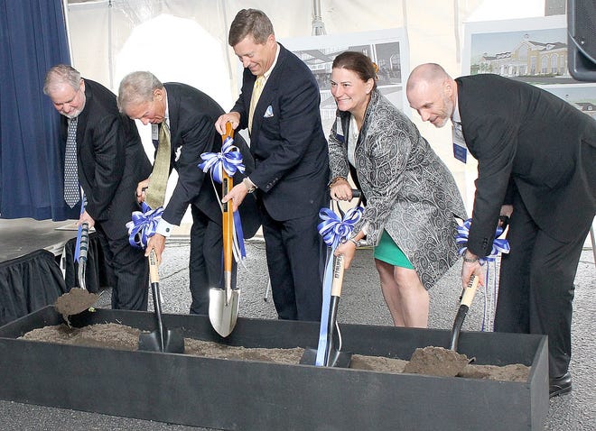 Hillsdale College President Larry Arnn (left) leads Bill Brodbeck, trustee; Gunnar Klarr, trustee; Louise Searle Klarr; and Rich Pewe, chief administration officer, in the turning of dirt for the new Searle Center Friday afternoon. ANDY BARRAND PHOTO